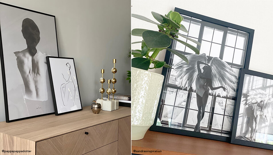 Mustavalkoiset taulut pystyssä piirongin päällä